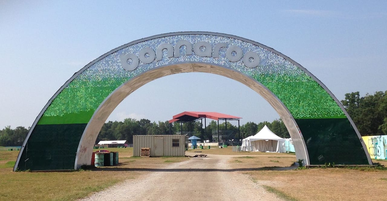 Outdoor concert crowd at Bonnaroo Music Festival in Tennessee under open skies
