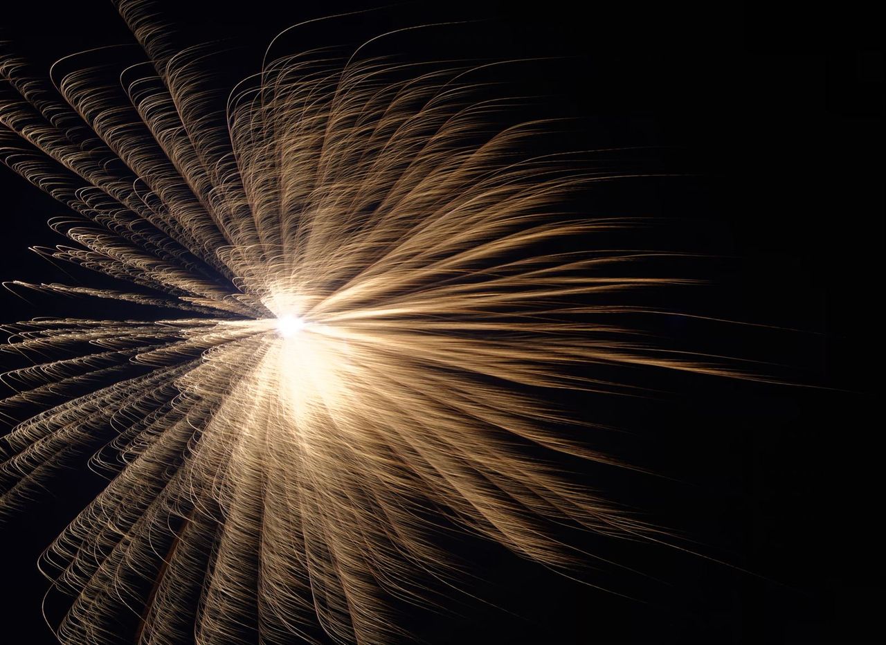 A long-exposure firework bursting in golden streaks against the black night sky during Diwali in Gurgaon, India