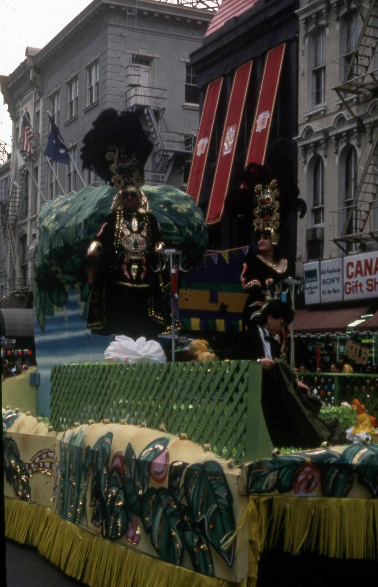 Colourful Mardi Gras parade floats moving through a packed street in New Orleans